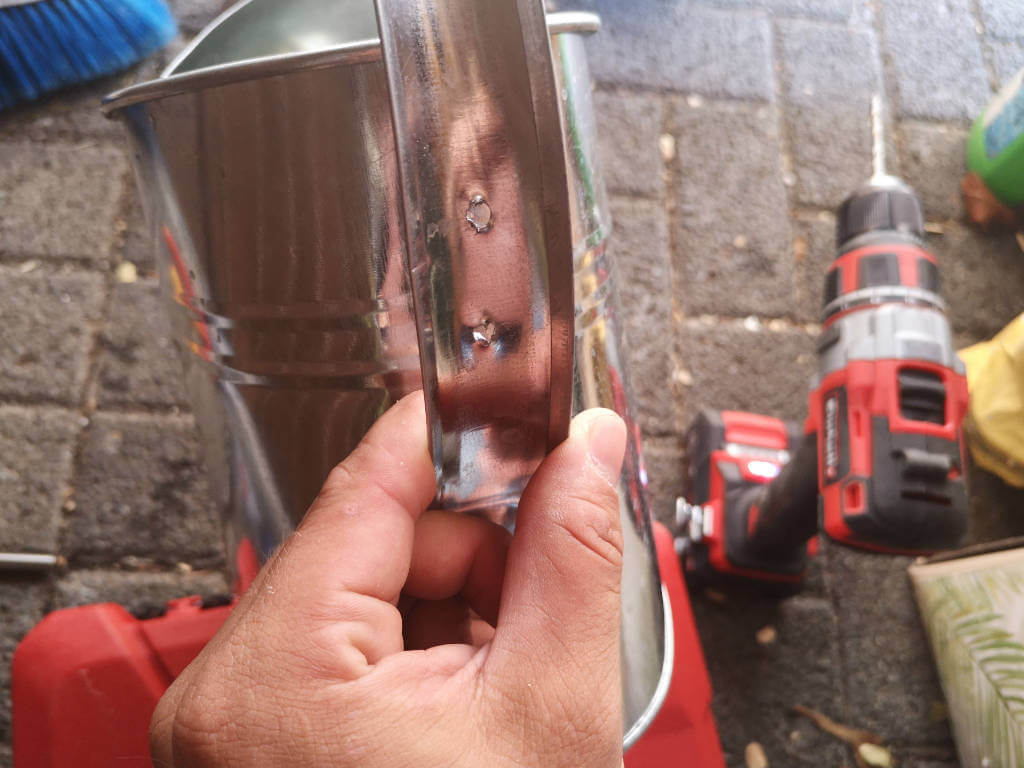 Watering can with pre-drilled holes