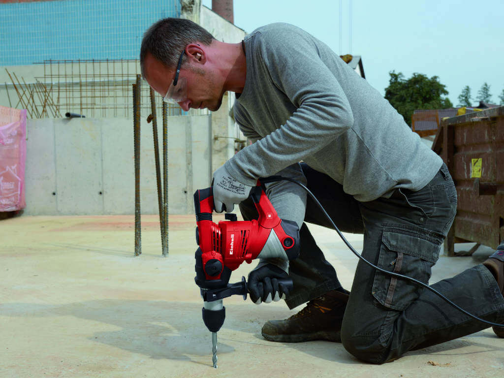 man working with driller 